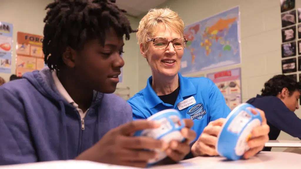 Cumberland Academy of Georgia teacher supporting a student during a classroom learning activity